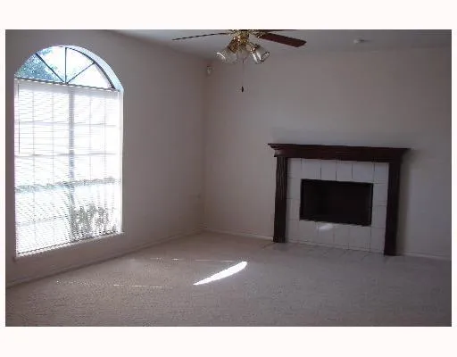 a view of empty room with a fireplace