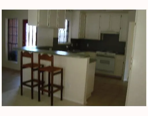 a kitchen with a table and chairs