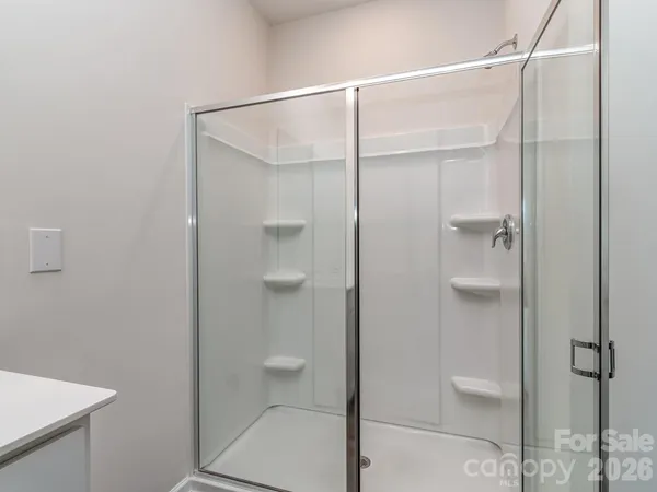 a bathroom that has a glass shower door