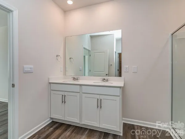 a bathroom with a double vanity sink and a mirror