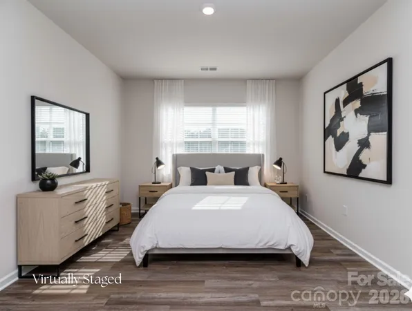 a spacious bedroom with a bed and window