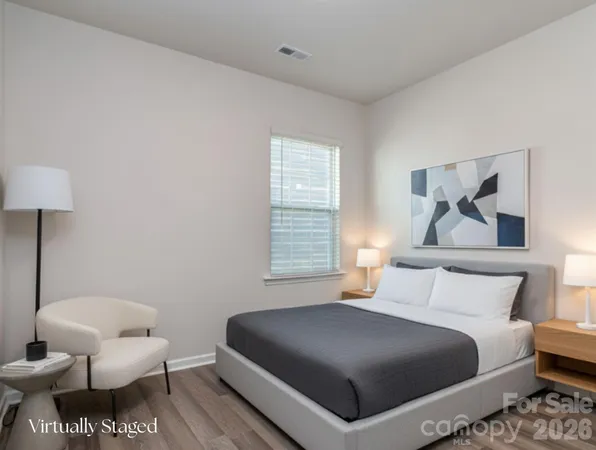 a bedroom with a bed and a couch