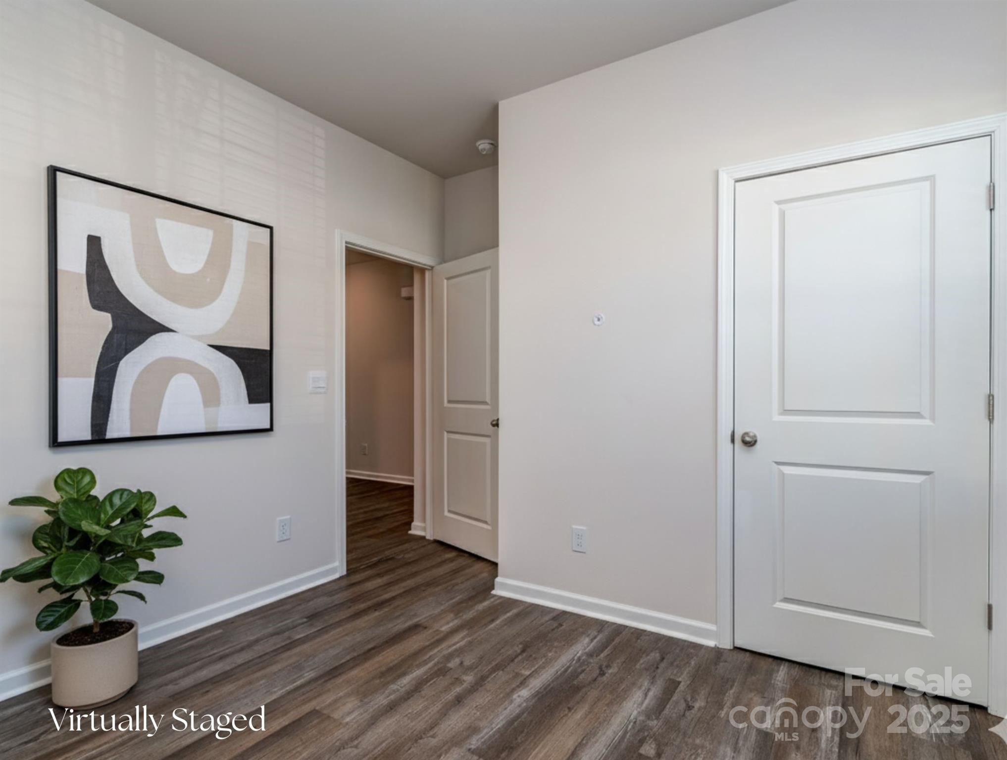 1843 Vanderlyn Street Monroe, NC 28112 - Photo 22 of 28 a view of a hallway with wooden floor and a potted plant