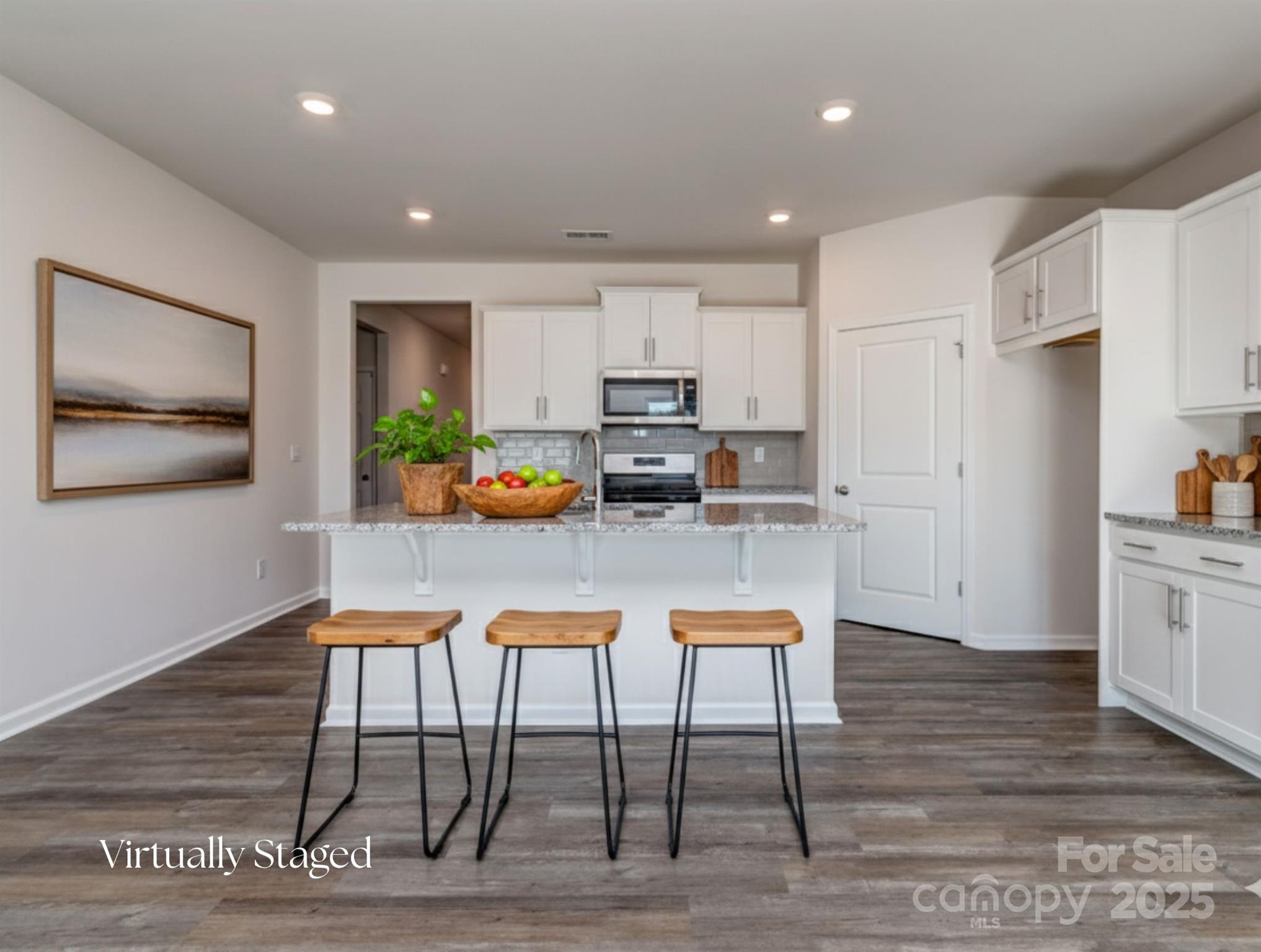 1843 Vanderlyn Street Monroe, NC 28112 - Photo 6 of 28 a kitchen with stainless steel appliances granite countertop a stove a refrigerator a kitchen island with a stove and white cabinets