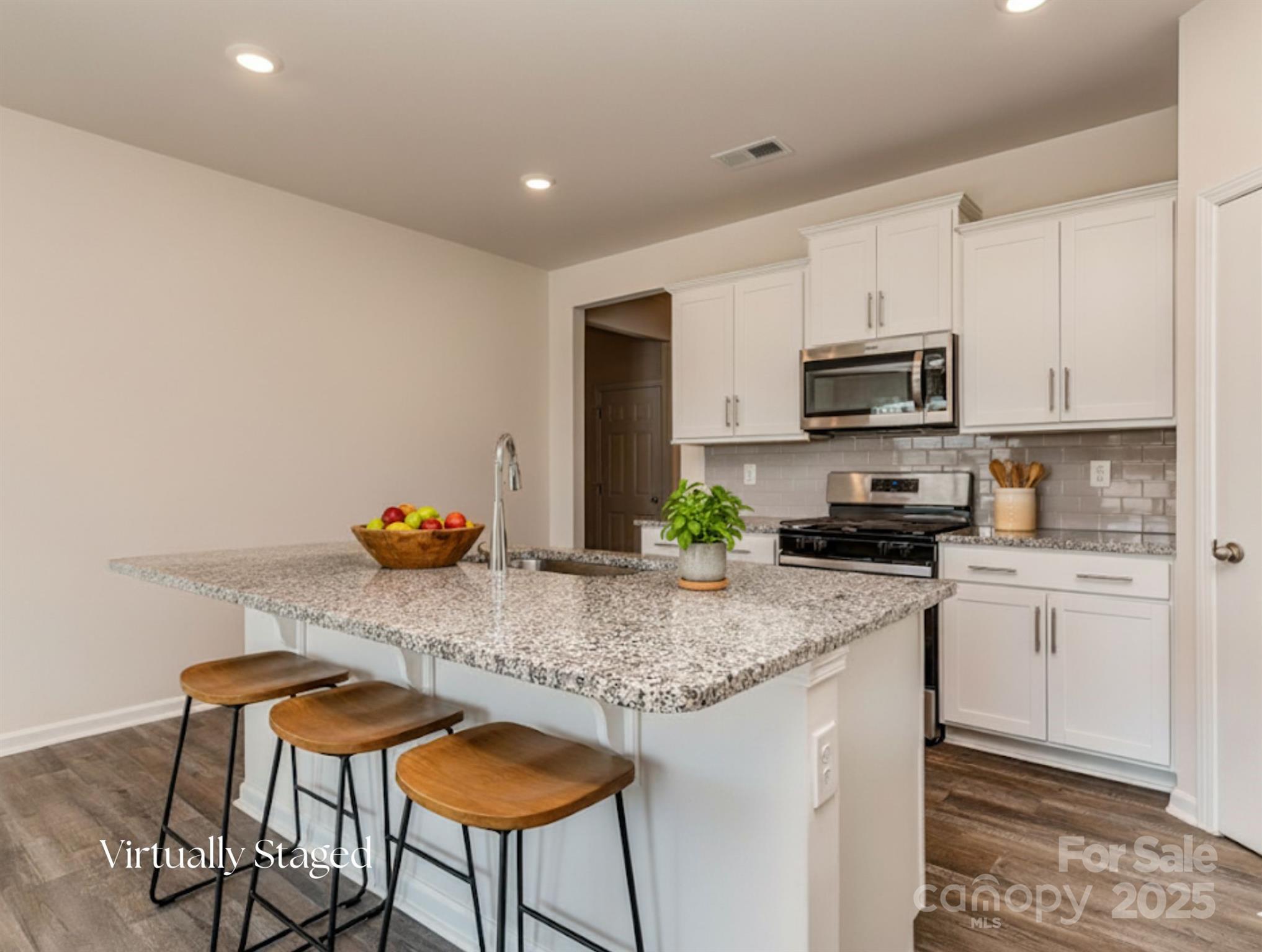 1843 Vanderlyn Street Monroe, NC 28112 - Photo 7 of 28 a kitchen with stainless steel appliances granite countertop a stove a sink cabinets and a refrigerator