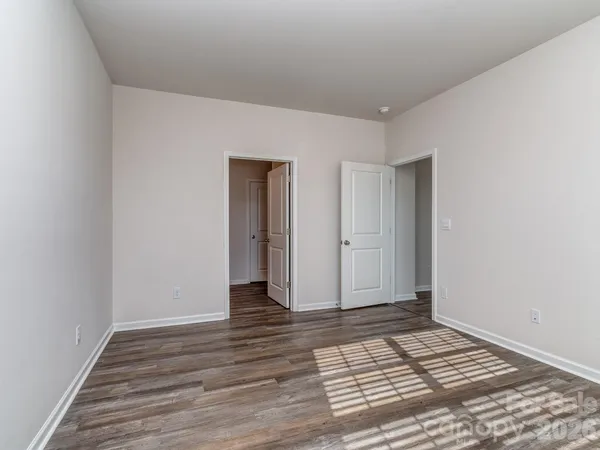 a view of an empty room and wooden floor