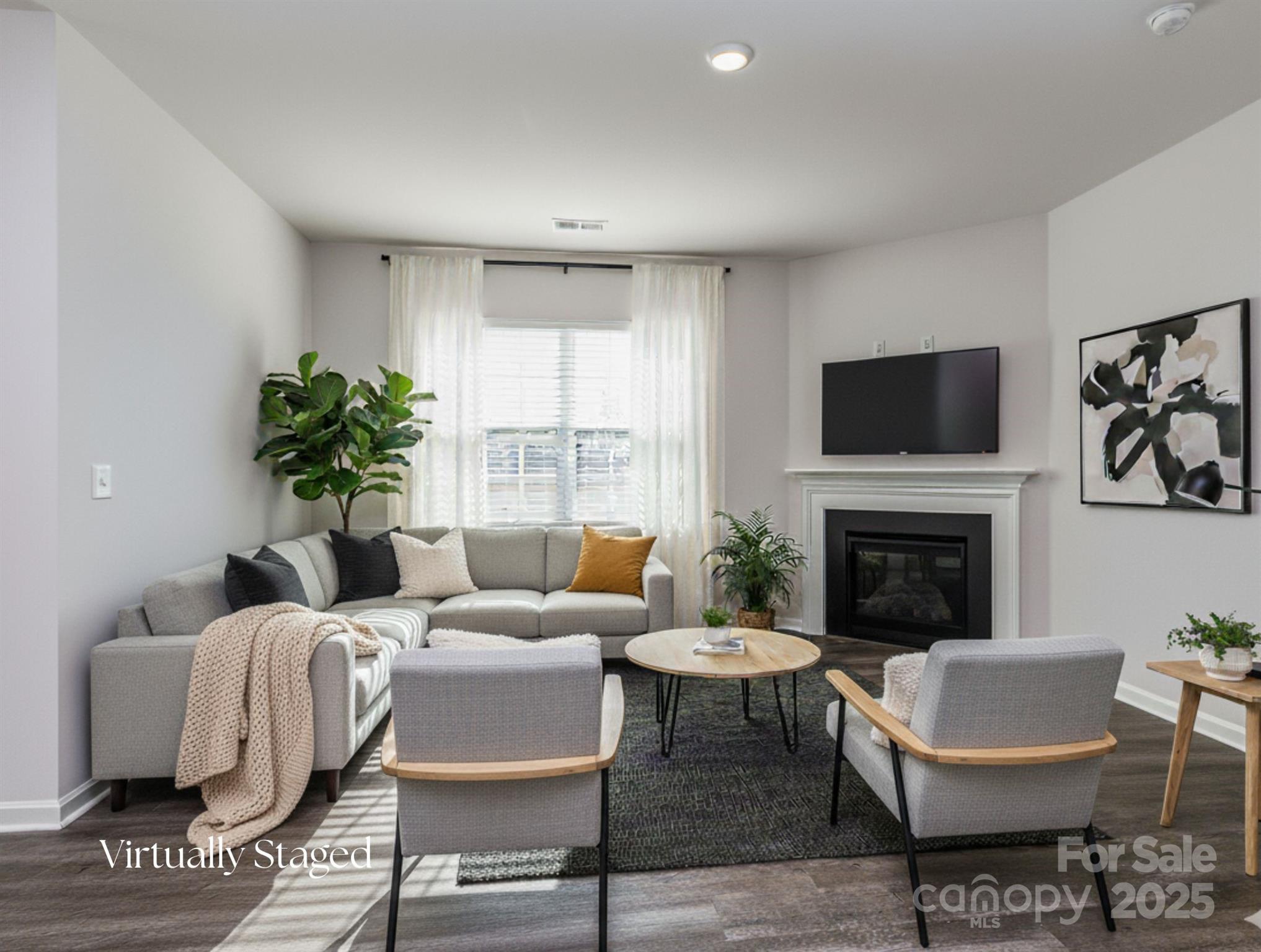 1843 Vanderlyn Street Monroe, NC 28112 - Photo 10 of 28 a living room with furniture a fireplace and a flat screen tv