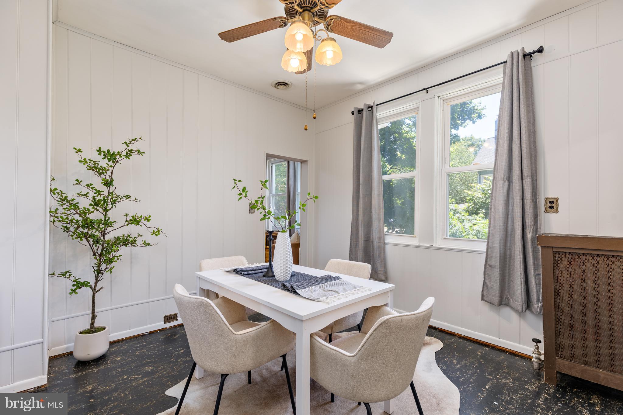 6426 Sherwood Road Baltimore, MD 21239 - Photo 10 of 43 a view of a dining room with furniture window and wooden floor