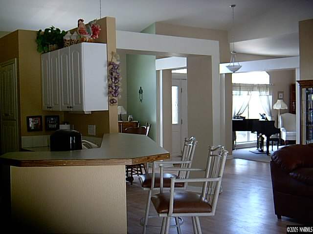 2420 Grizzley Road Reno, NV 89521 - Photo 5 of 9 a kitchen with stainless steel appliances granite countertop a table chairs and a refrigerator