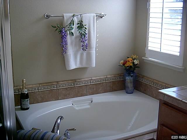 2420 Grizzley Road Reno, NV 89521 - Photo 8 of 9 a bathroom with a tub and a window