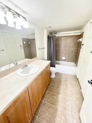a bathroom with a tub sink and a mirror