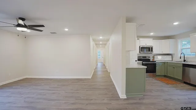 a view of kitchen with sink microwave and refrigerator