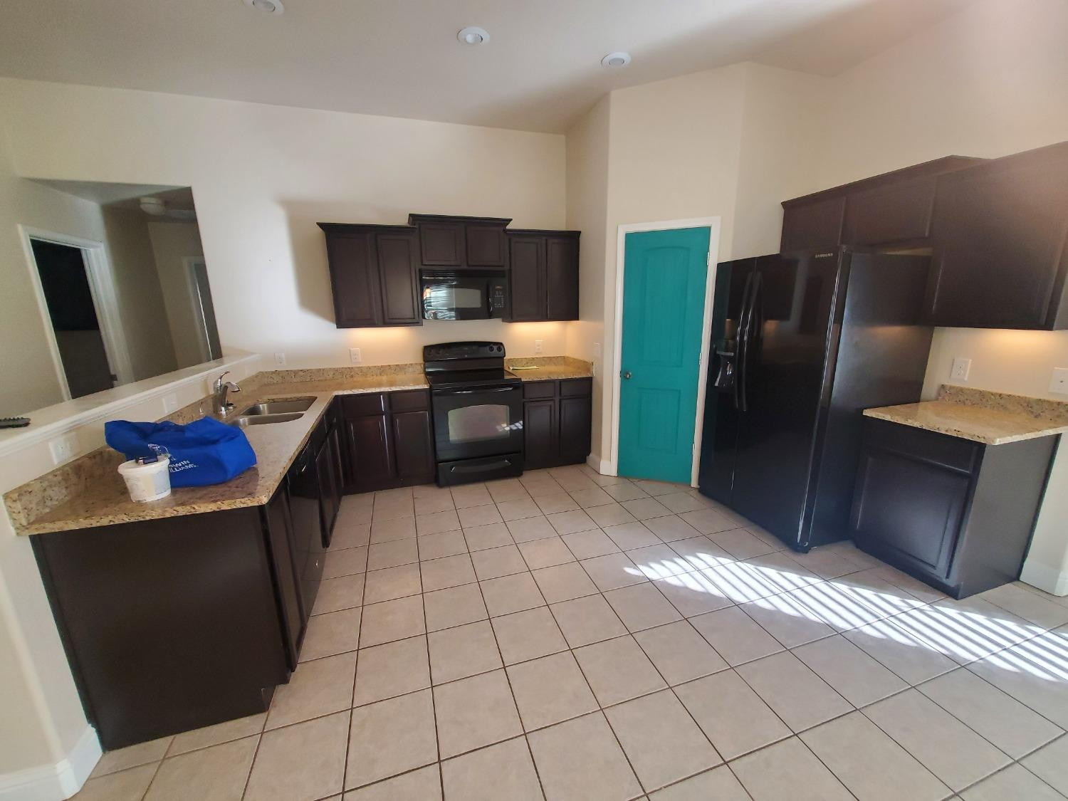5603 110th Street Lubbock, TX 79424 - Photo 4 of 12 a kitchen with stainless steel appliances a refrigerator and a stove