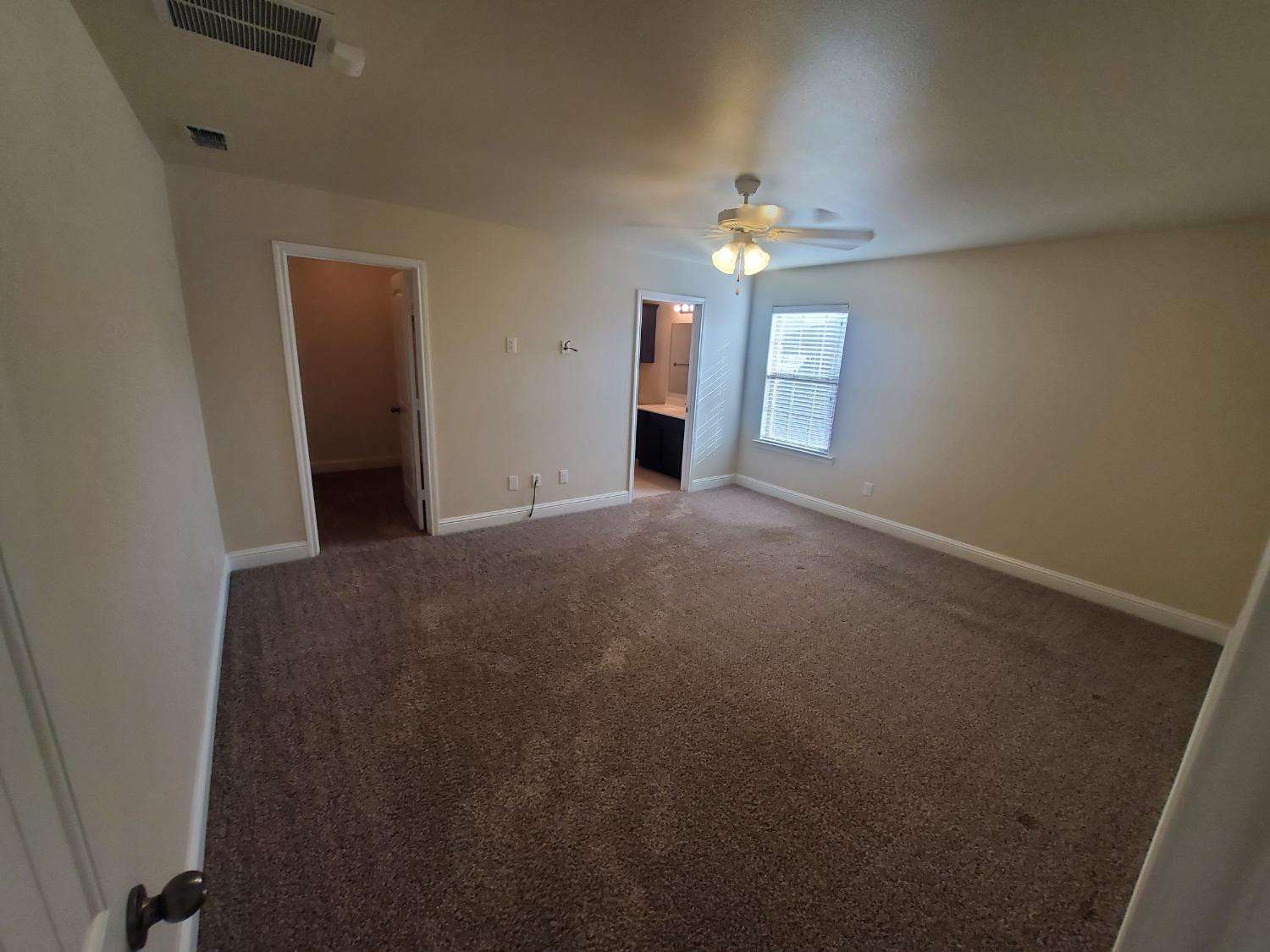 5603 110th Street Lubbock, TX 79424 - Photo 5 of 12 a view of an empty room with a window