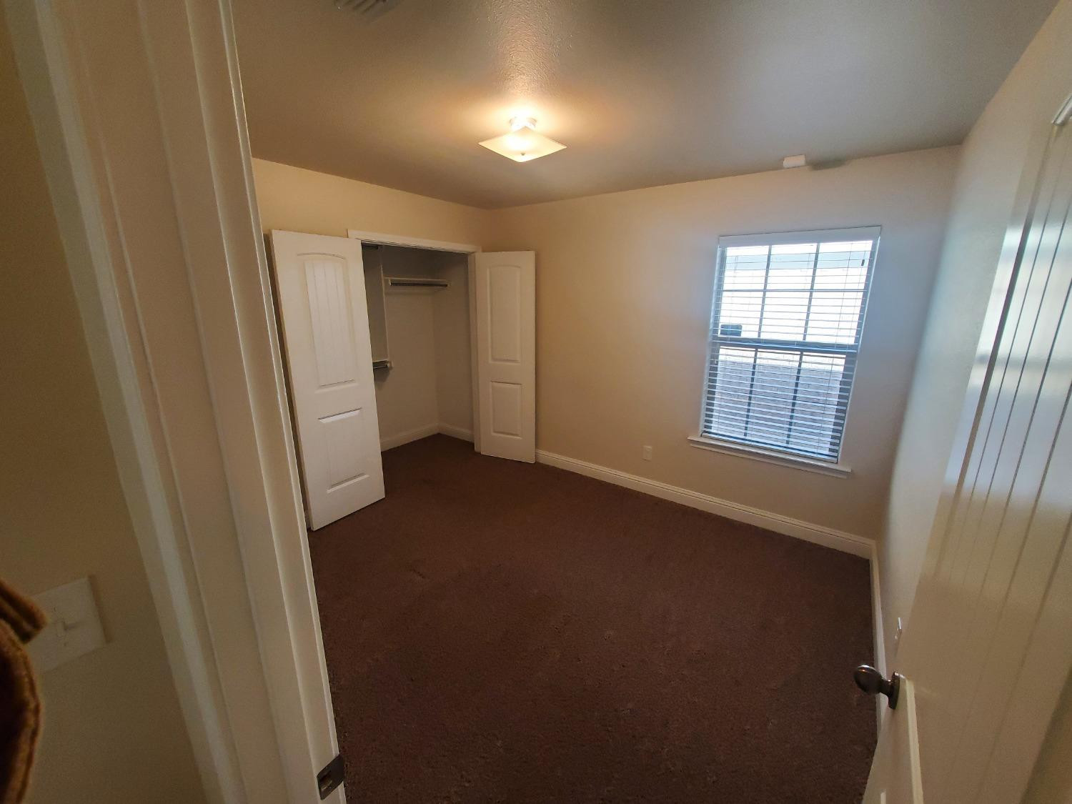 5603 110th Street Lubbock, TX 79424 - Photo 7 of 12 an empty room with windows