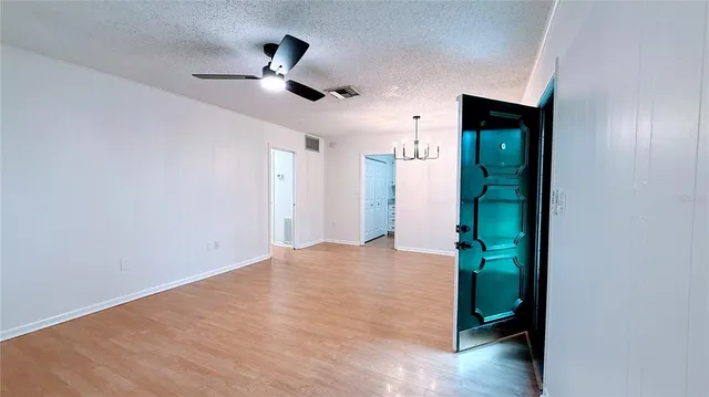 a view of an empty room with a ceiling fan