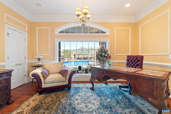 a view of a dining room with furniture and chandelier