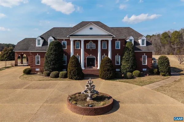 an aerial view of a house with swimming pool having outdoor seating