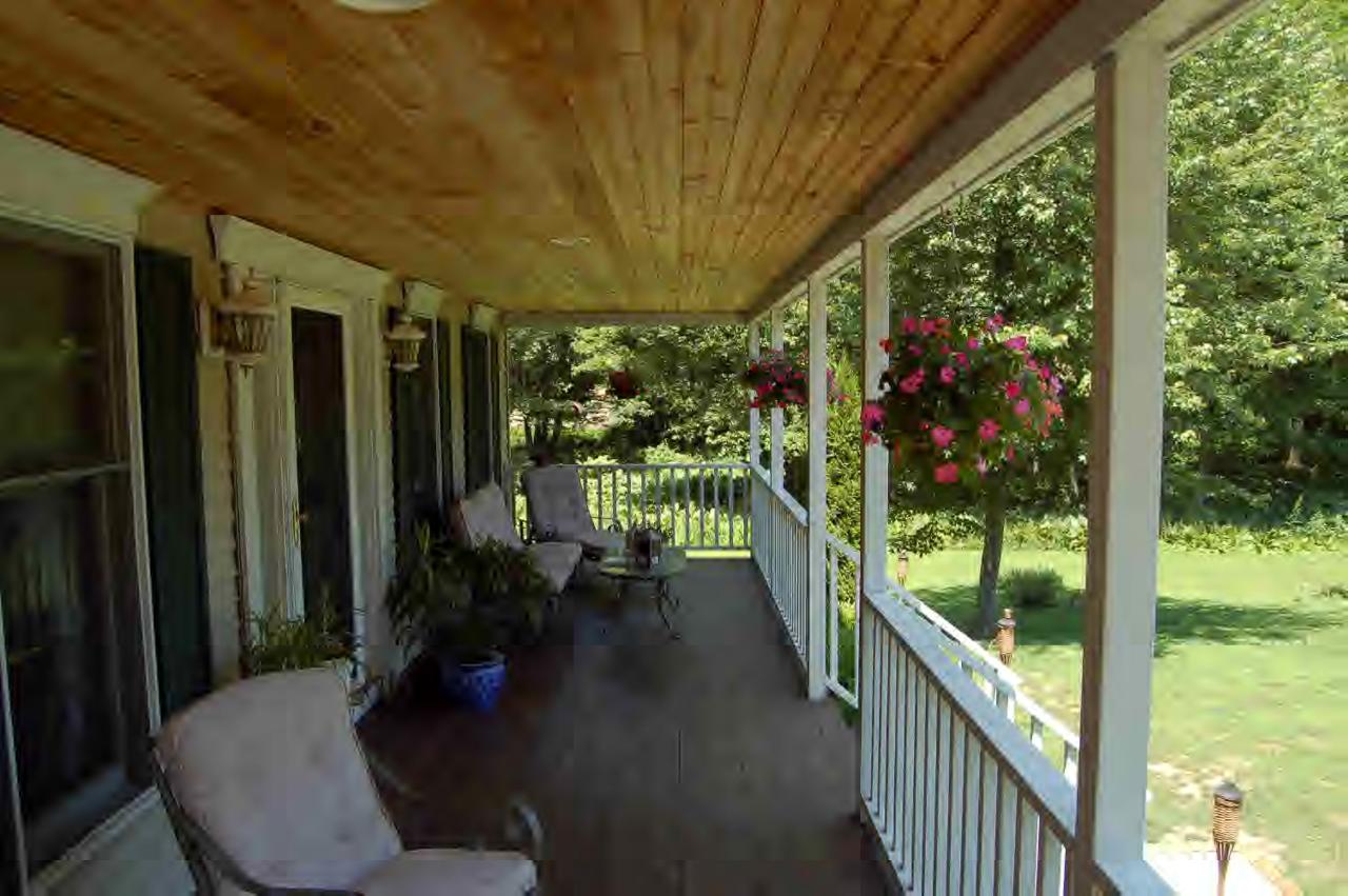 114 Salisbury Road Sheffield, MA 01257 - Photo 2 of 8 a porch with chairs and table in patio