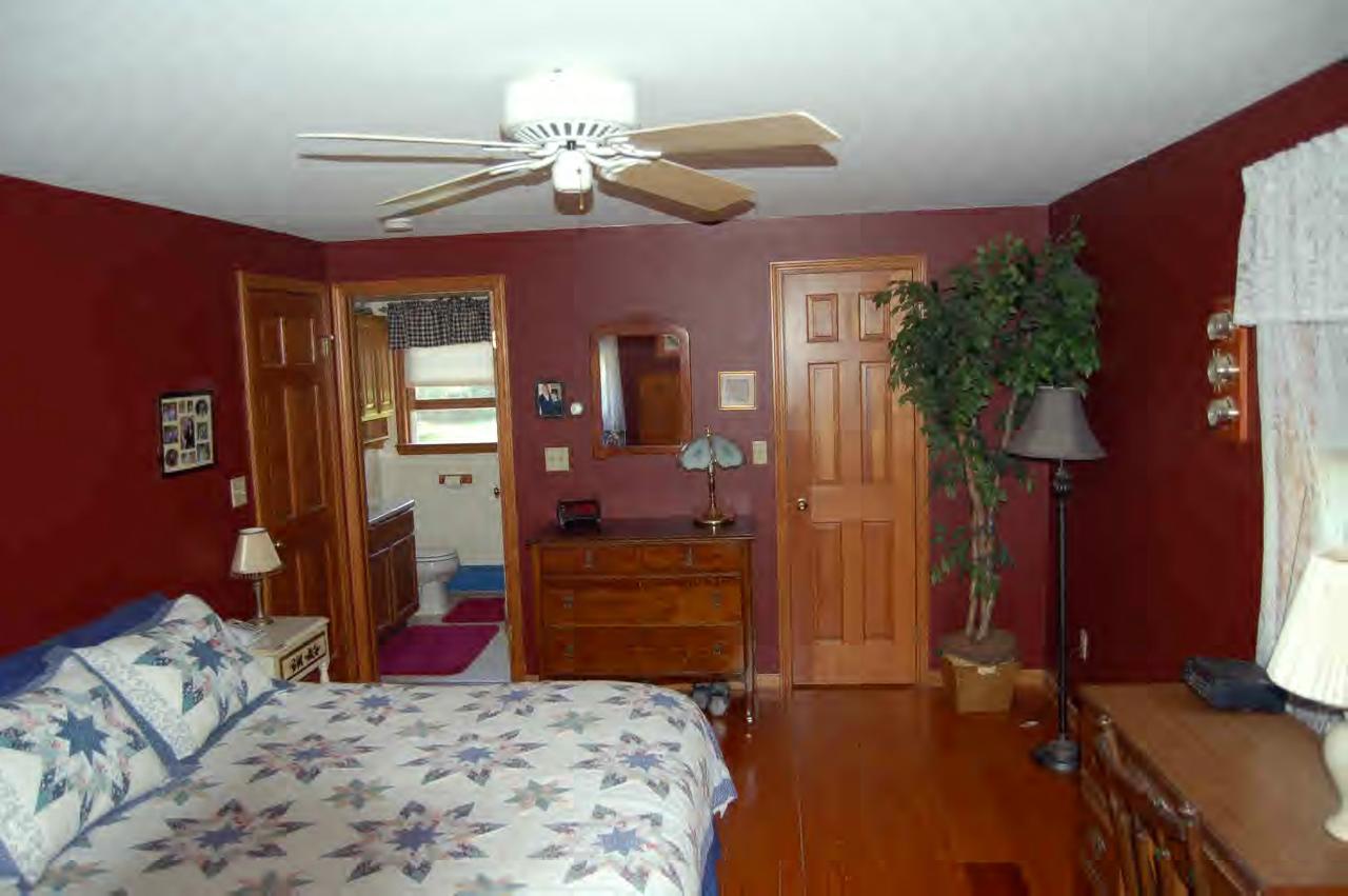 114 Salisbury Road Sheffield, MA 01257 - Photo 6 of 8 a bedroom with a bed and a chandelier