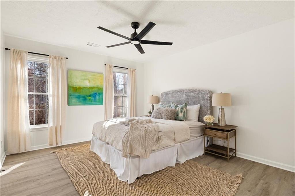 540 Riverside Road Sugar Hill, GA 30518 - Photo 11 of 25 a bedroom with a bed and wooden floor