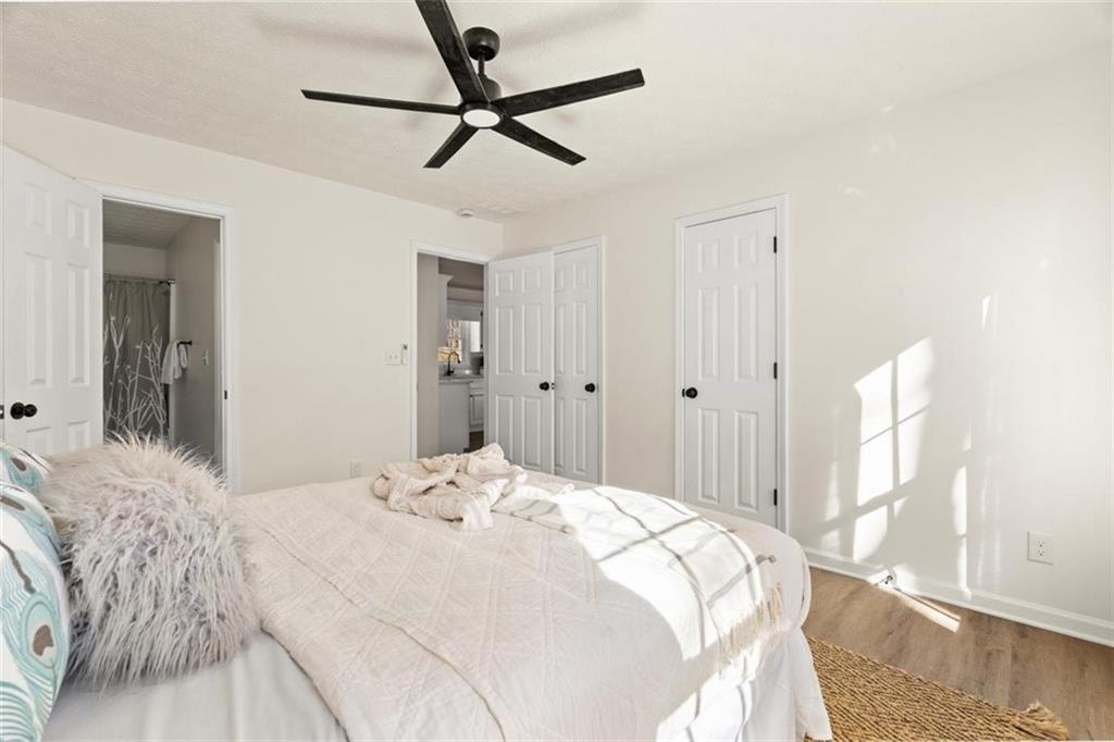 540 Riverside Road Sugar Hill, GA 30518 - Photo 12 of 25 a bedroom with a bed and a chandelier