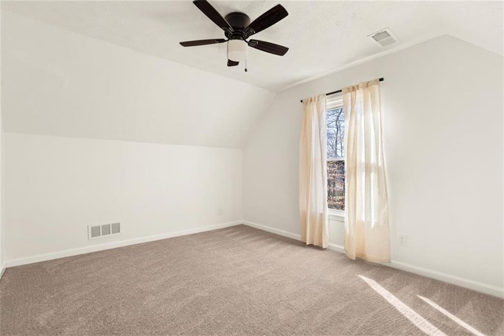 540 Riverside Road Sugar Hill, GA 30518 - Photo 14 of 25 an empty room with windows and ceiling fan