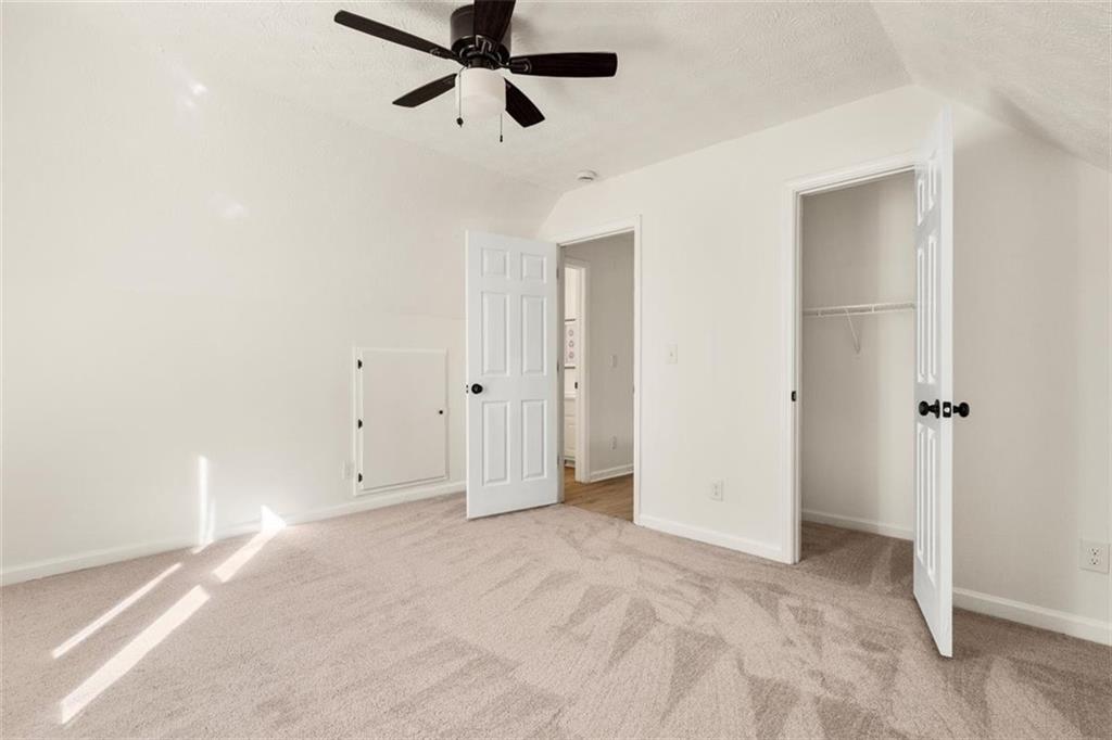 540 Riverside Road Sugar Hill, GA 30518 - Photo 15 of 25 a view of a room with a ceiling fan and window