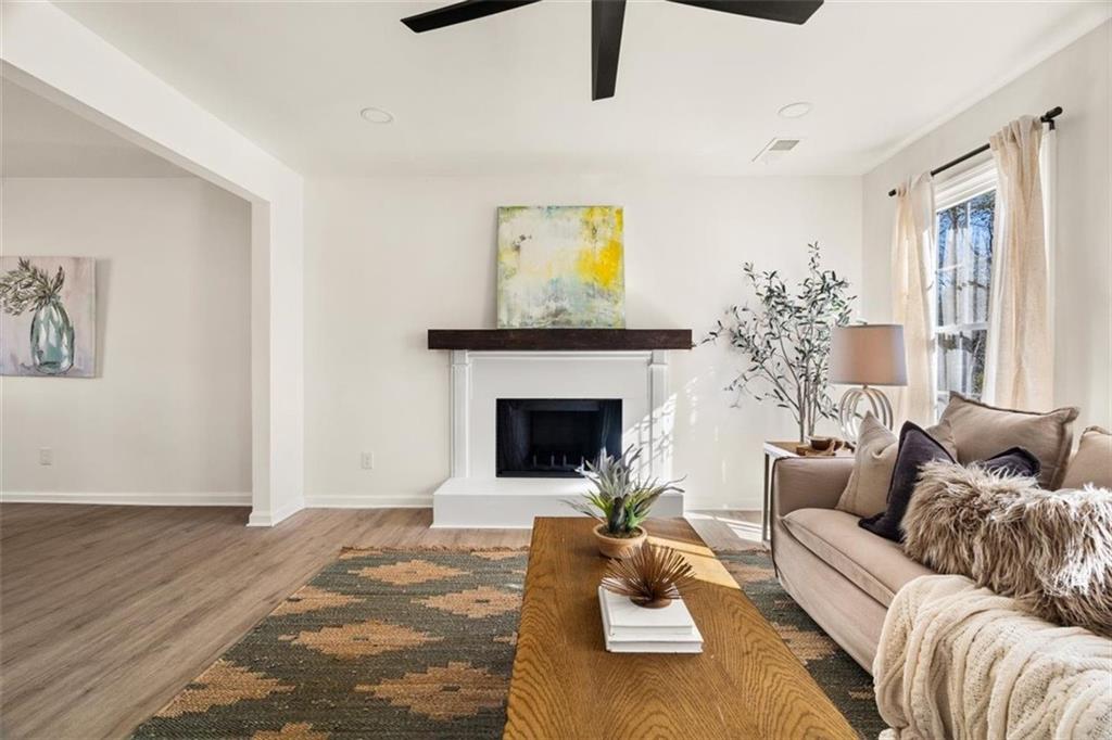 540 Riverside Road Sugar Hill, GA 30518 - Photo 3 of 25 a living room with furniture and a fireplace