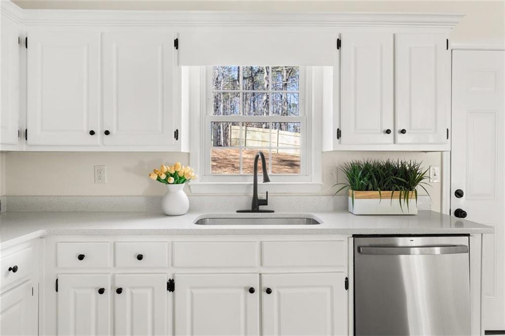 540 Riverside Road Sugar Hill, GA 30518 - Photo 7 of 25 a kitchen with white cabinets and window