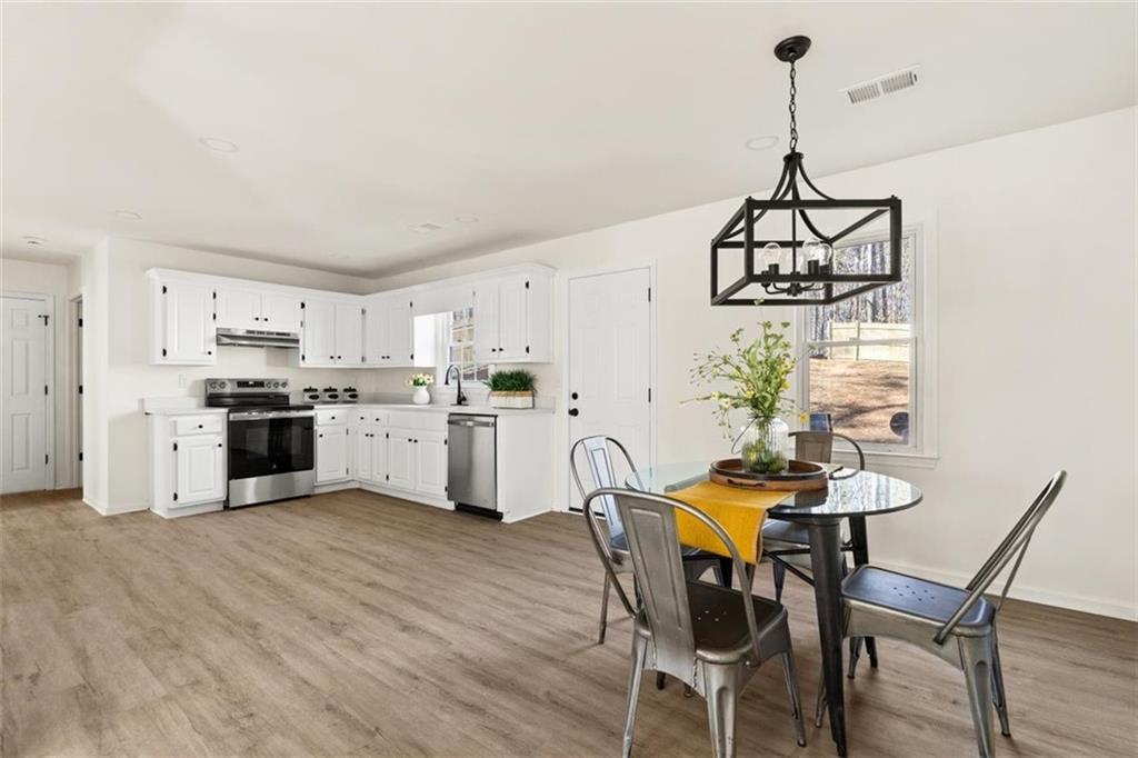 540 Riverside Road Sugar Hill, GA 30518 - Photo 10 of 25 a view of a dining room with furniture and chandelier