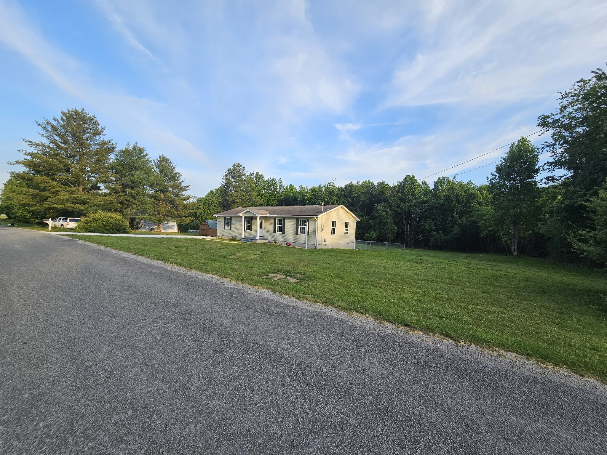 362 Forest Point Road Monteagle, TN 37356 - Photo 11 of 42 a view of a road with a big yard and large trees