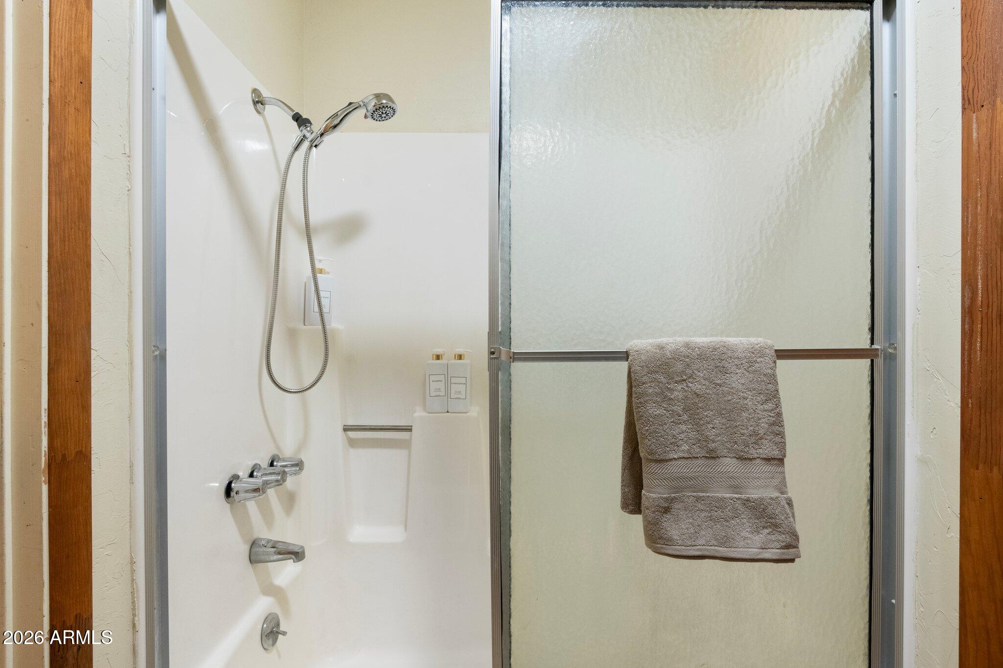 10434 Little Red Road Parks, AZ 86018 - Photo 13 of 35 a bathroom with a glass shower door