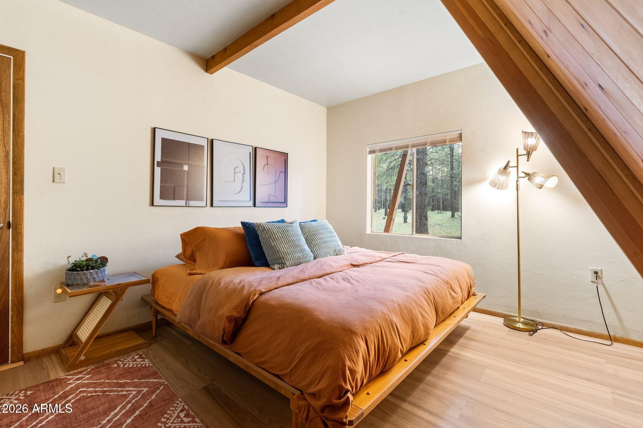 10434 Little Red Road Parks, AZ 86018 - Photo 22 of 35 a bedroom with a bed and wooden floor
