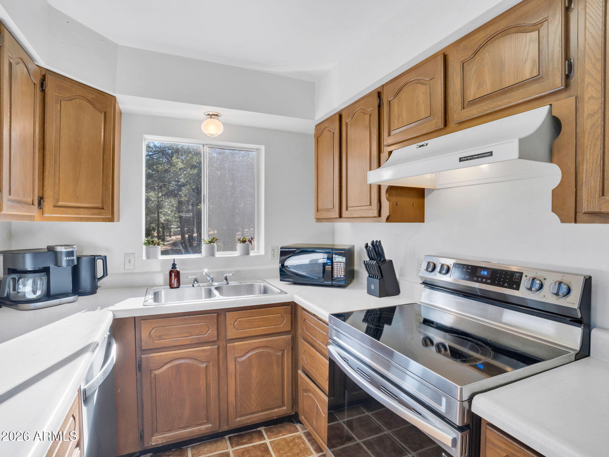 10434 Little Red Road Parks, AZ 86018 - Photo 8 of 35 a kitchen with stainless steel appliances a sink a stove and cabinets