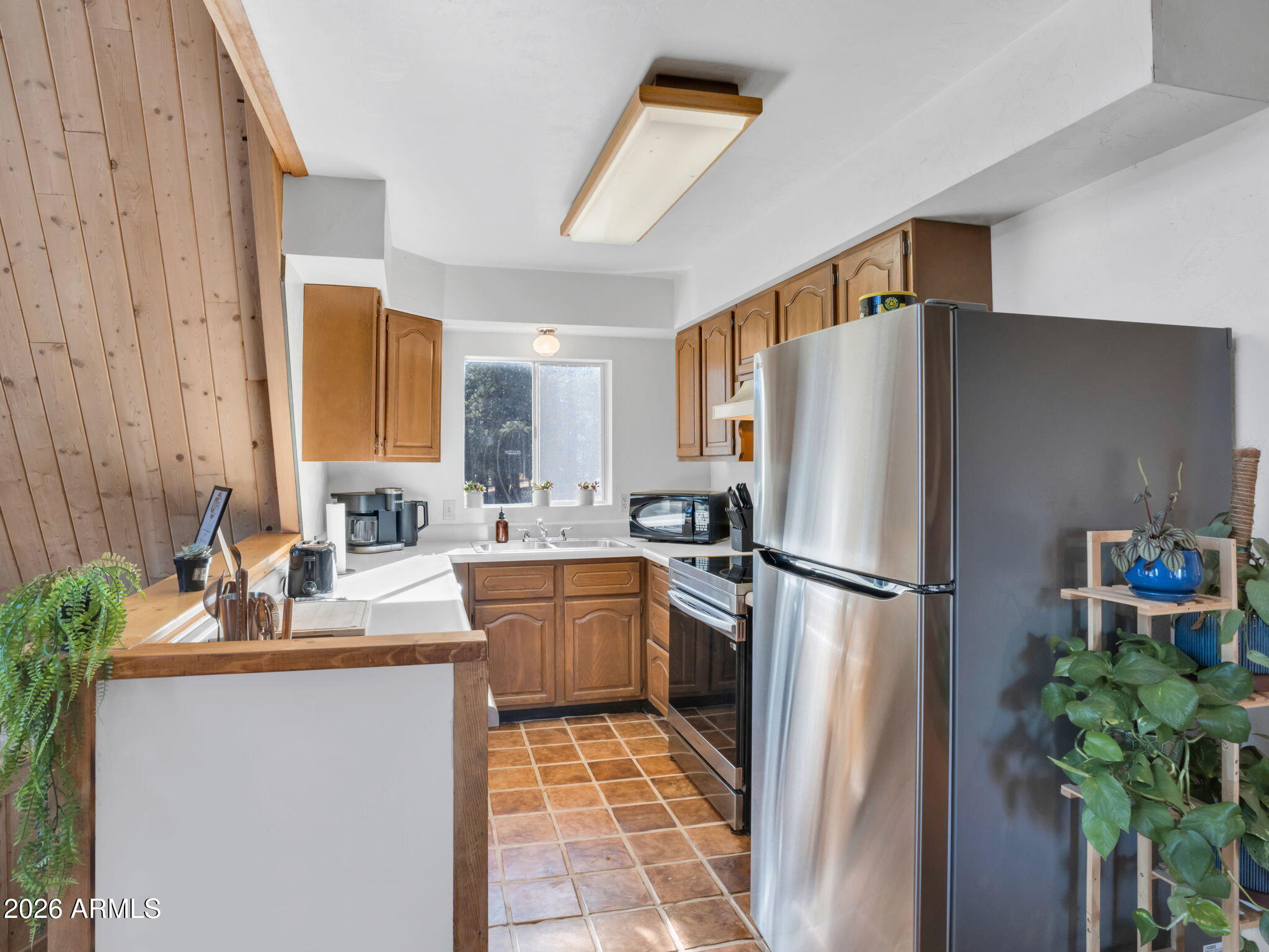 10434 Little Red Road Parks, AZ 86018 - Photo 9 of 35 a kitchen with stainless steel appliances granite countertop a refrigerator a sink a stove a dining table and chairs