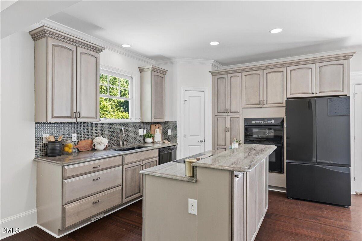 1304 Flying Hawk Road Apex, NC 27523 - Photo 11 of 52 a kitchen with a refrigerator sink and cabinets