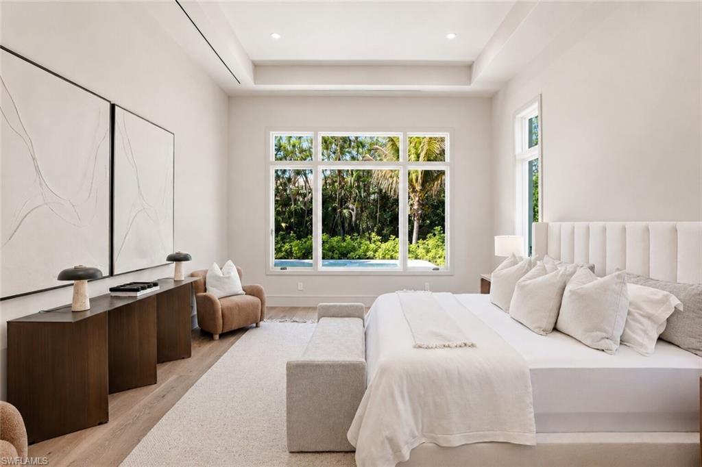 4851 Crayton Road Naples, FL 34103 - Photo 14 of 33 Spacious room featuring light wood-finish flooring, a tray ceiling, and recessed lighting