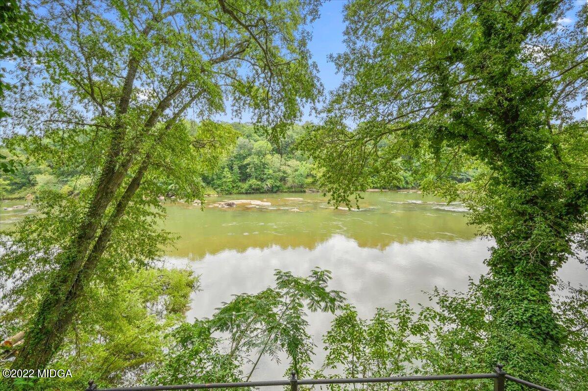 1 River Trace Macon, GA 31210 - Photo 19 of 62 a view of a lake in between the top of green field