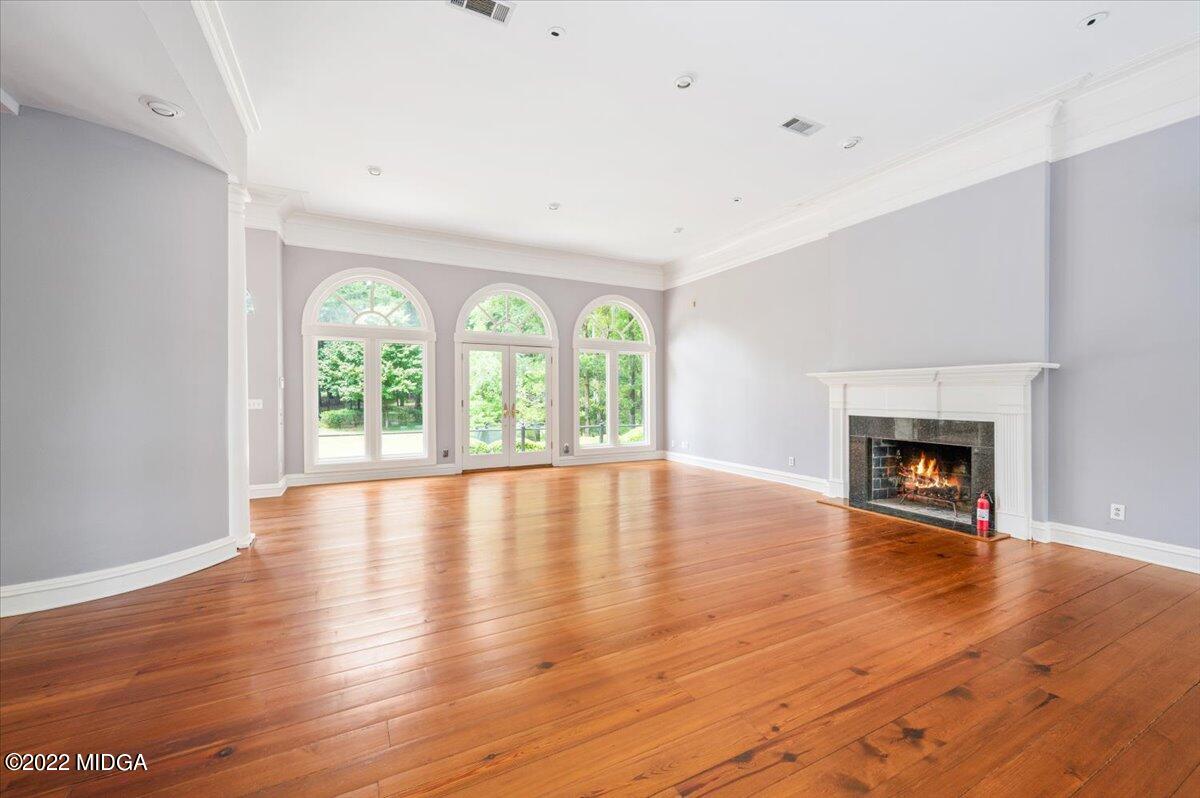 1 River Trace Macon, GA 31210 - Photo 44 of 62 an empty room with wooden floor fireplace and windows