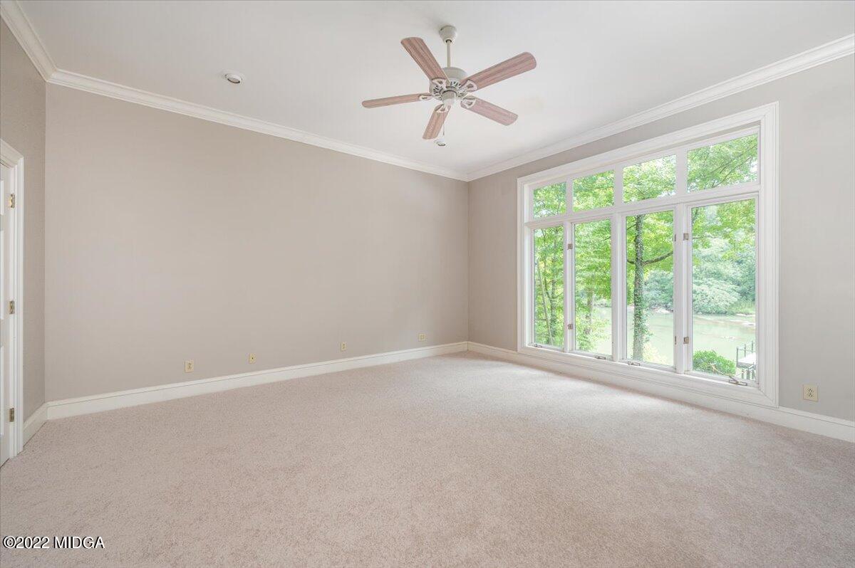 1 River Trace Macon, GA 31210 - Photo 49 of 62 an empty room with a ceiling fan and windows
