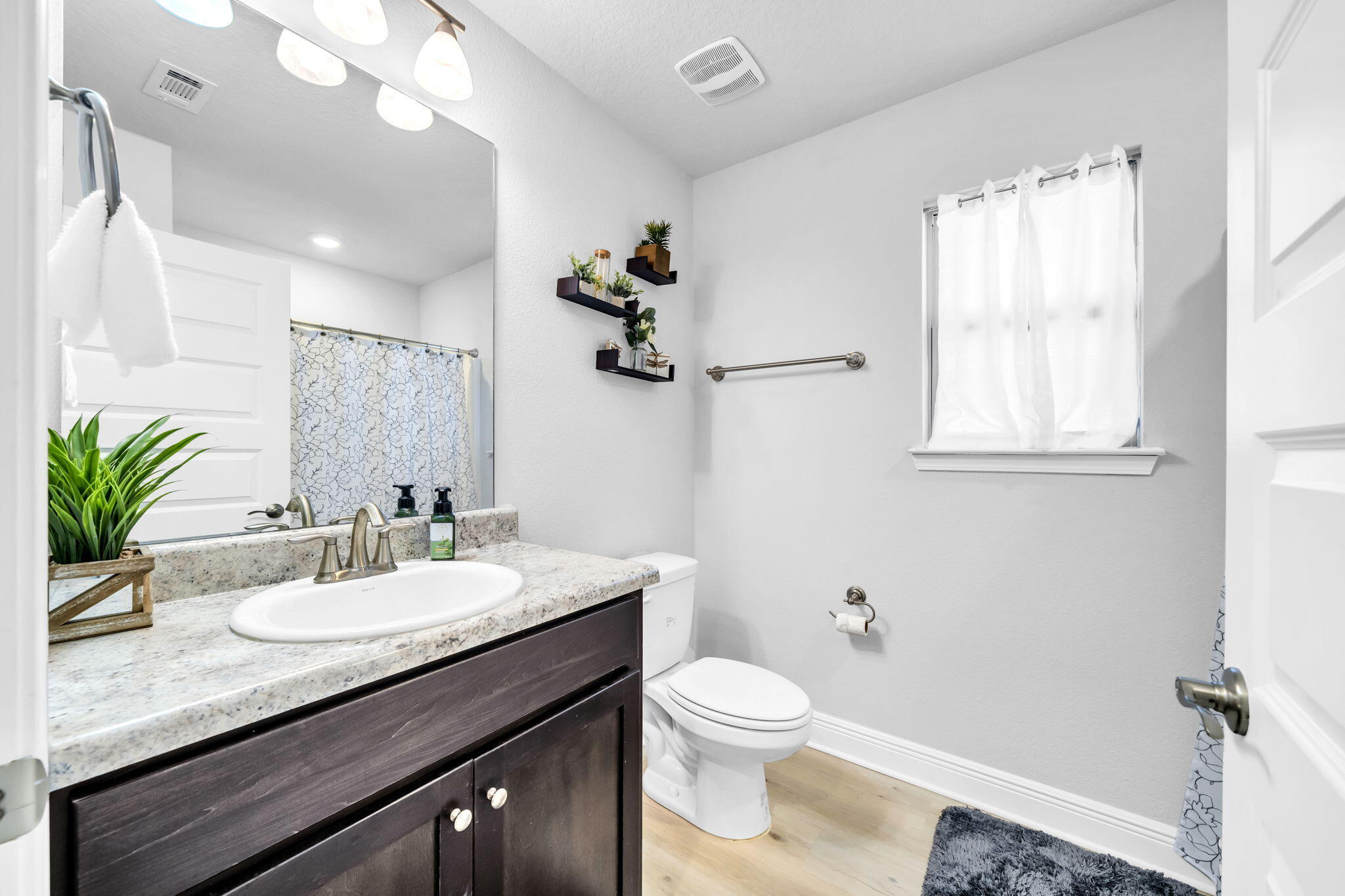 125 Ridgeway Circle Crestview, FL 32536 - Photo 12 of 41 a bathroom with a granite countertop sink a toilet a mirror and shower