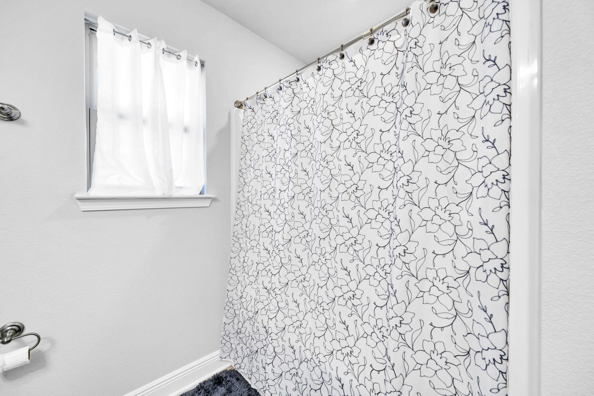 125 Ridgeway Circle Crestview, FL 32536 - Photo 13 of 41 a bathroom with a shower curtain and a window