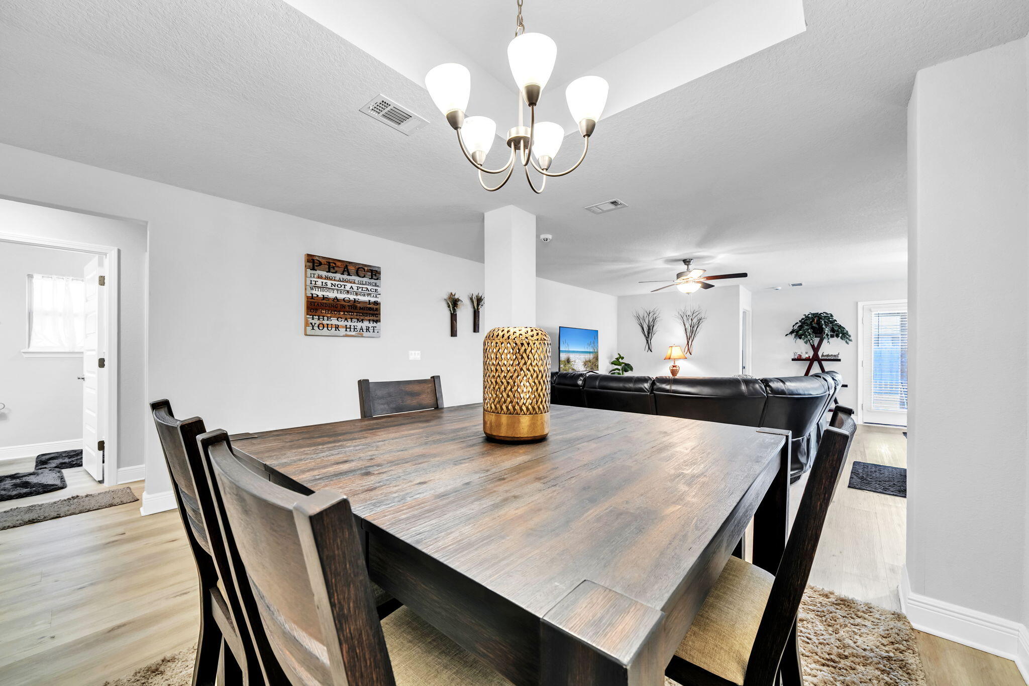 125 Ridgeway Circle Crestview, FL 32536 - Photo 18 of 41 a dining room with wooden floor a chandelier a wooden table and chairs