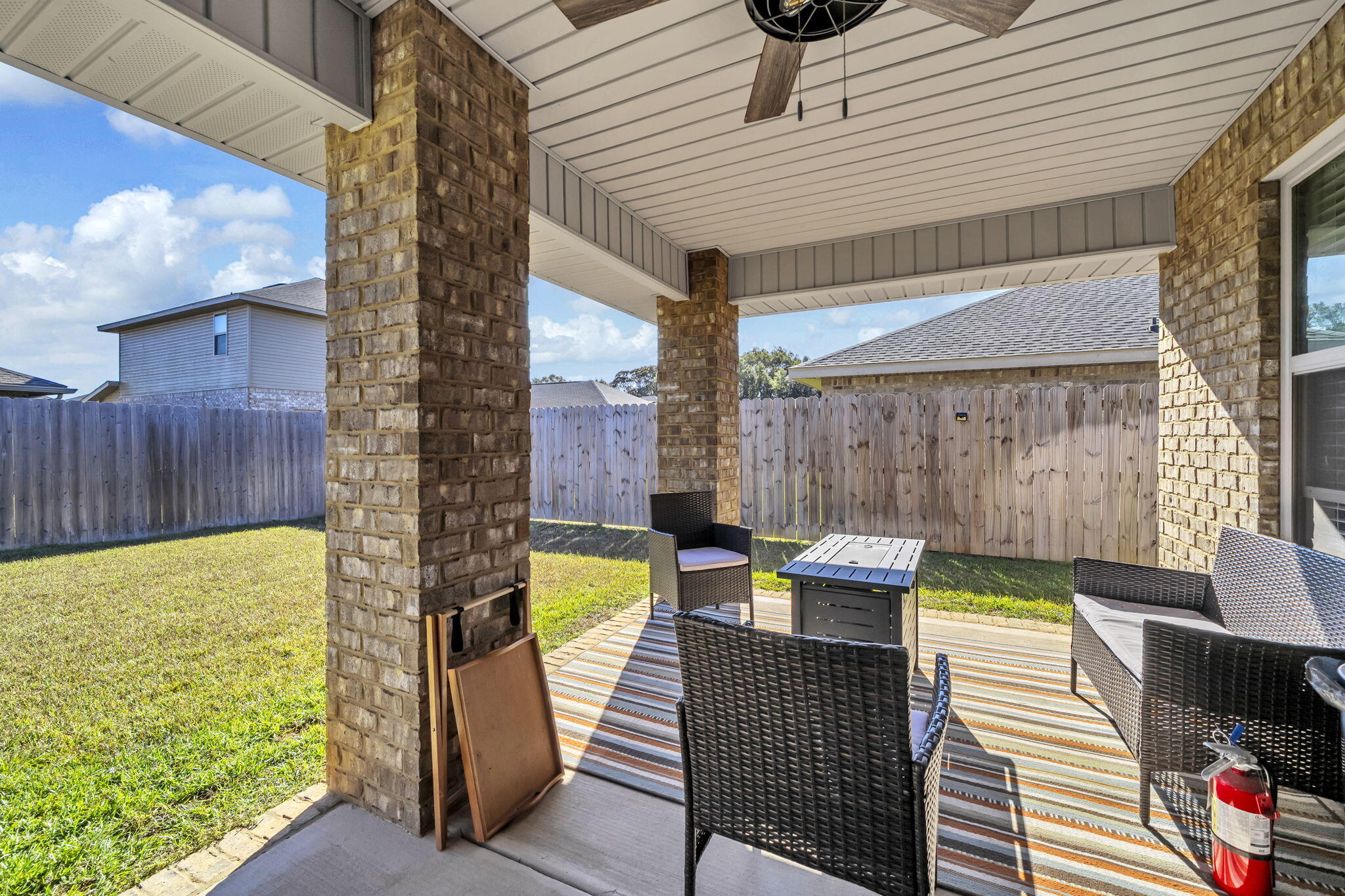 125 Ridgeway Circle Crestview, FL 32536 - Photo 36 of 41 a view of a patio with table and chairs with wooden floor and fence
