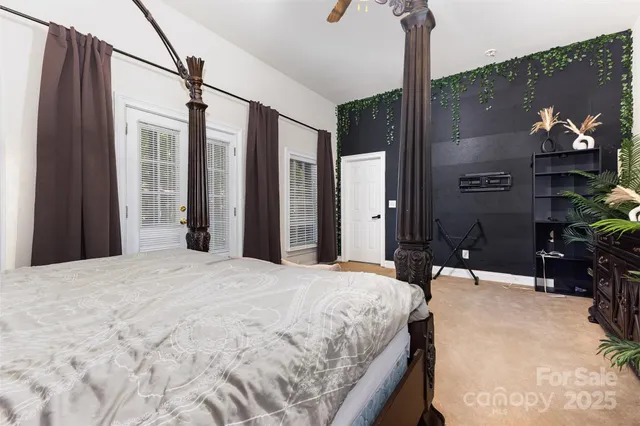 a bed sitting in a bedroom and mirror