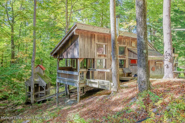a view of house with a yard and sitting area