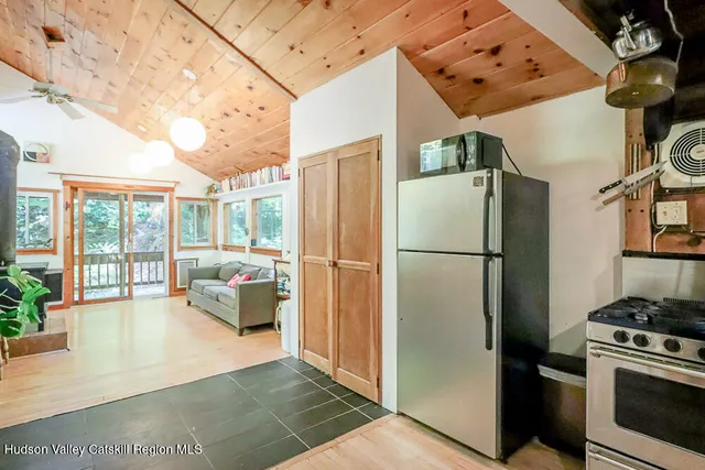 a kitchen with a sink a stove a dining table and chairs