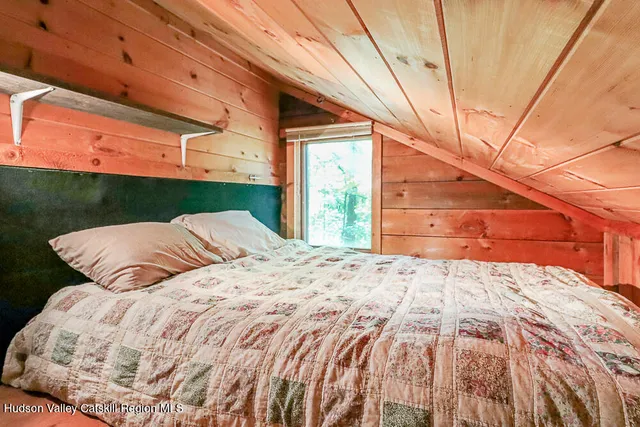 a bathroom with a tub a sink and a window