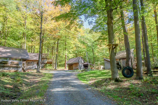 a view of a house with backyard and a tree